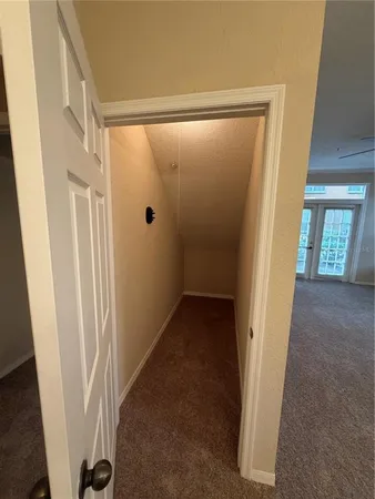 a view of a hallway with a livingroom and a bathroom