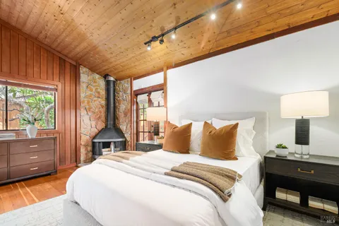 a view of a bedroom with furniture and window