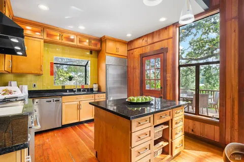 a kitchen with stainless steel appliances granite countertop sink stove and granite counter top