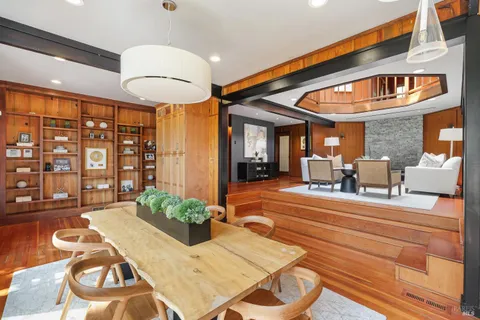 a lobby with furniture and chandelier