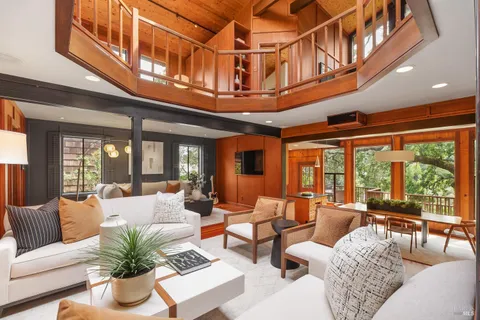 a living room with furniture or chandelier and a large window