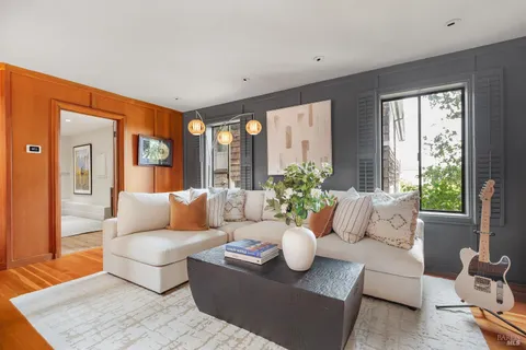 a living room with furniture and a potted plant