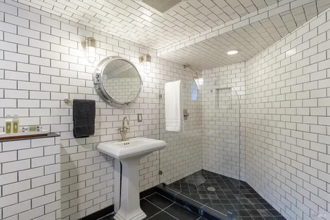 a bathroom with a sink a toilet and a mirror