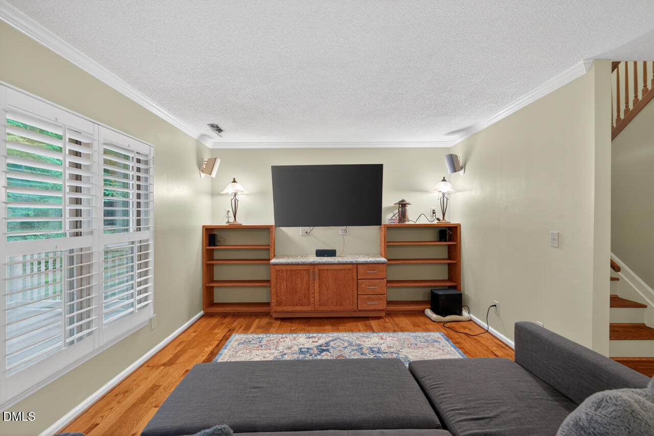 3307 Coachman's Way Durham, NC 27705 - Photo 18 of 50 a room with furniture and a flat screen tv