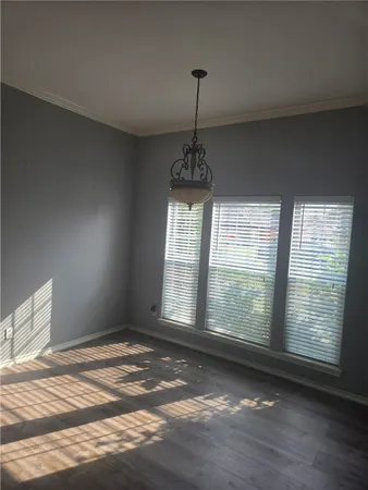 a view of an empty room with windows
