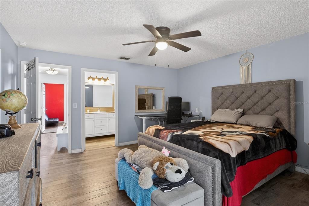 622 Ridge Terrace Winter Haven, FL 33881 - Photo 21 of 29 a bedroom with a bed and wooden floor