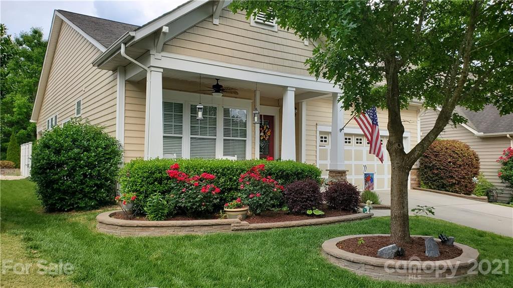 86578 Arrington Road Lancaster, SC 29720 - Photo 2 of 3 a front view of a house with a yard garage and fountain