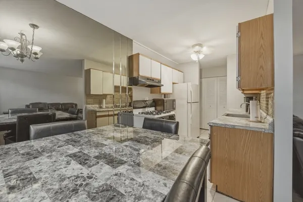 a kitchen with stainless steel appliances granite countertop a sink refrigerator stove and microwave