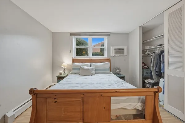 a bedroom with a bed and a window