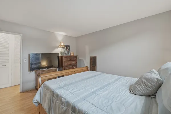 a bedroom with a bed and a television