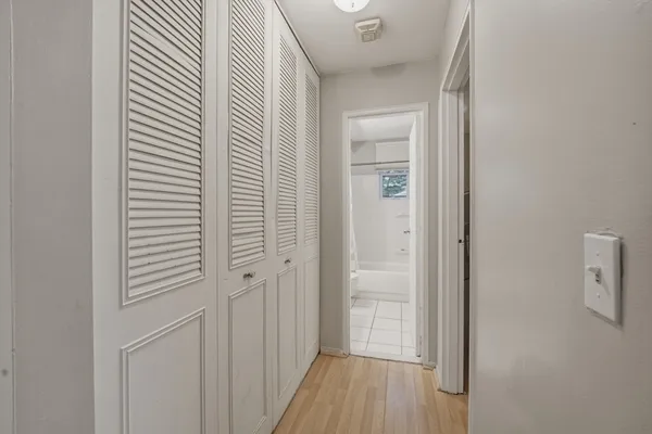 a view of a hallway with wooden floor