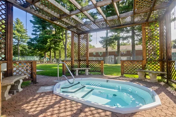 a small pool with view of a yard