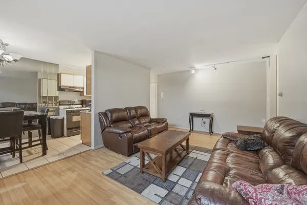 a living room with furniture and kitchen view