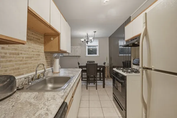 a kitchen with a sink stove and refrigerator