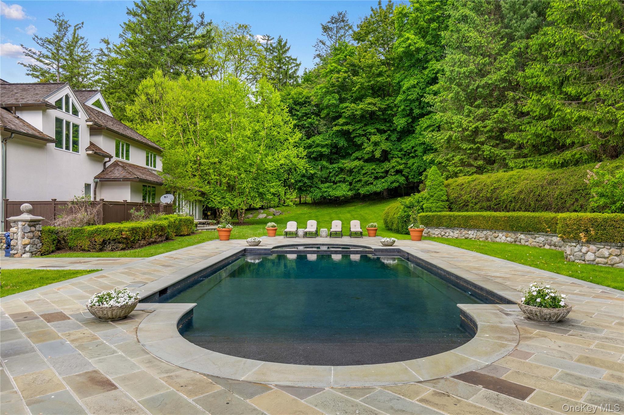 150 Old Farm Road North Chappaqua, NY 10514 - Photo 36 of 44 a view of a swimming pool with a garden