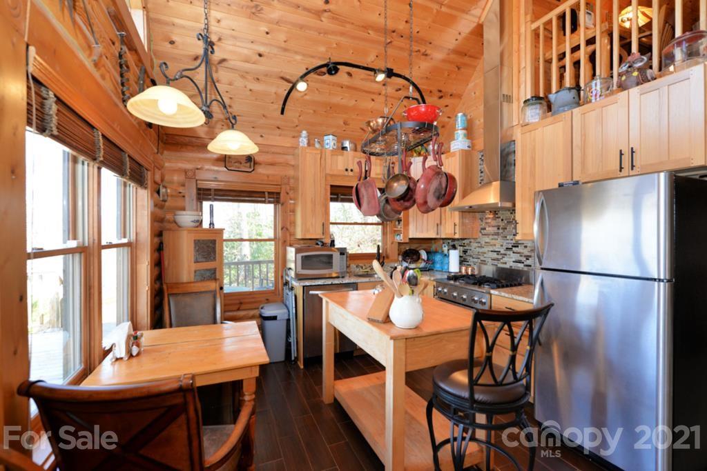 175 Owl Lookout Sylva, NC 28779 - Photo 11 of 20 a view of a dining room with furniture and chandelier