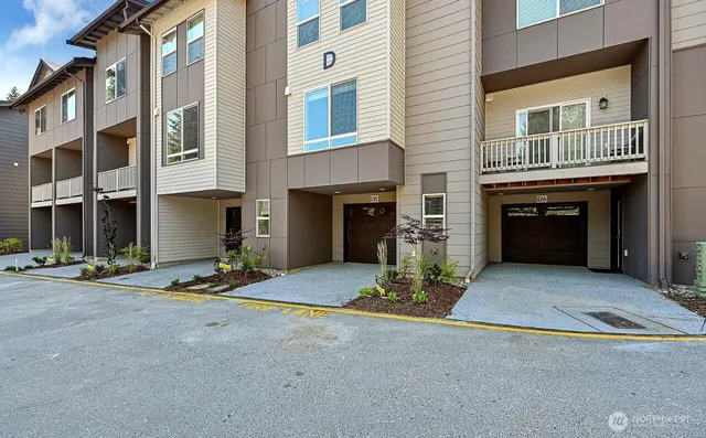 a front view of a house with yard and parking
