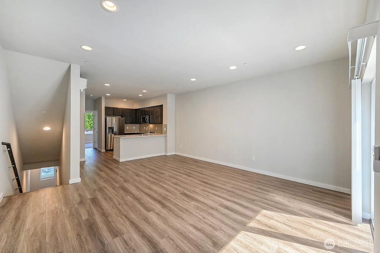 13117 3rd Avenue Southeast, Unit D5 Everett, WA 98208 - Photo 5 of 22 a view of a big room with wooden floor and a kitchen