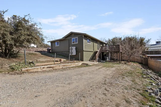 a view of a house with a yard covered in snow