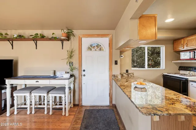 a large kitchen with a table and chairs