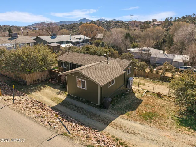an aerial view of a house with a mountain