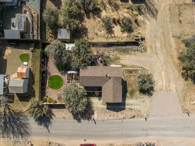 an aerial view of residential house with outdoor space and seating area
