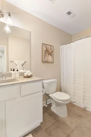 a bathroom with a toilet sink and a mirror