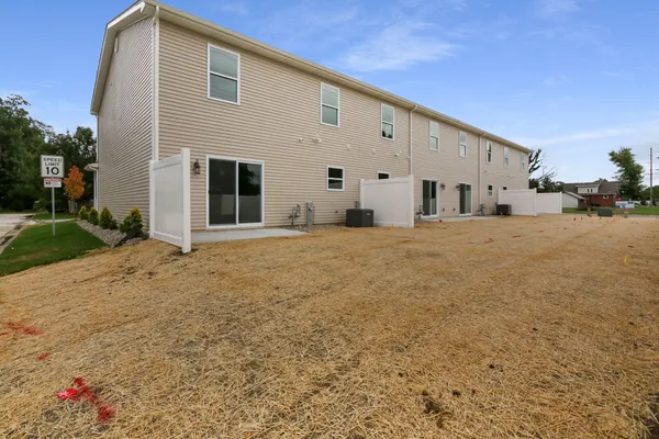 a large white house with a large space in front of it
