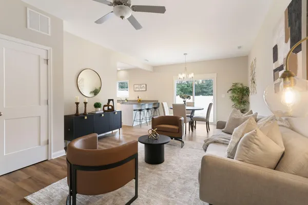 a living room with furniture a window and a chandelier