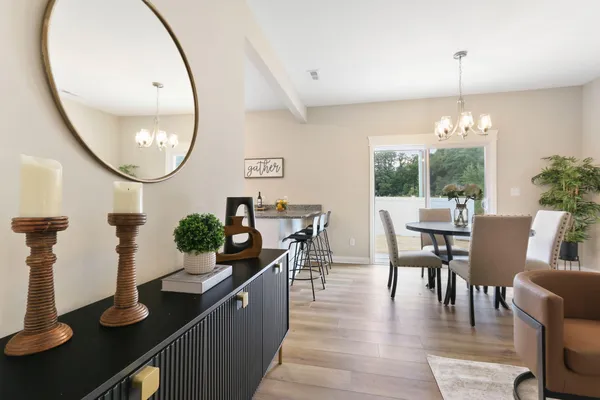 a dining room with furniture and wooden floor