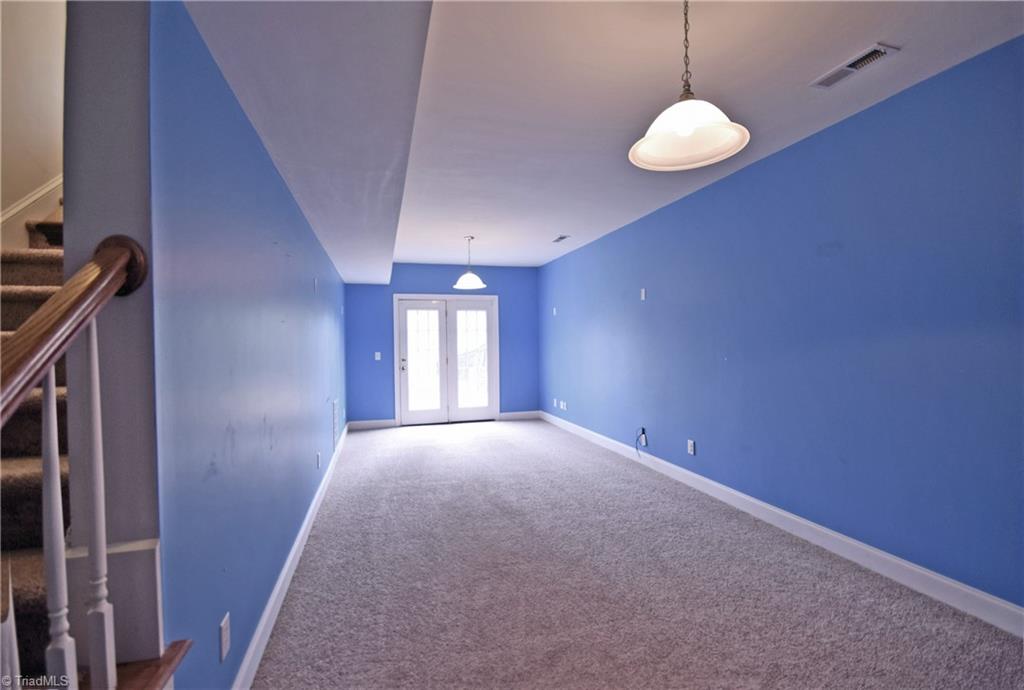 4021 Clinard Road Clemmons, NC 27012 - Photo 20 of 23 Bonus room in basement with French doors that lead to the fenced backyard.