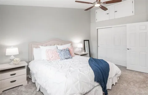 a bedroom with a bed and a ceiling fan