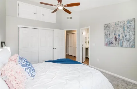 a bedroom with a large bed and a chandelier