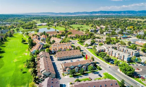 an aerial view of residential houses with outdoor space and street view