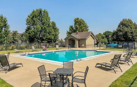 a view of a swimming pool with chairs