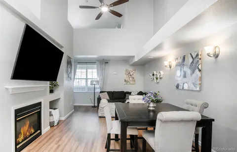 a view of a livingroom with furniture a flat screen tv and a fireplace