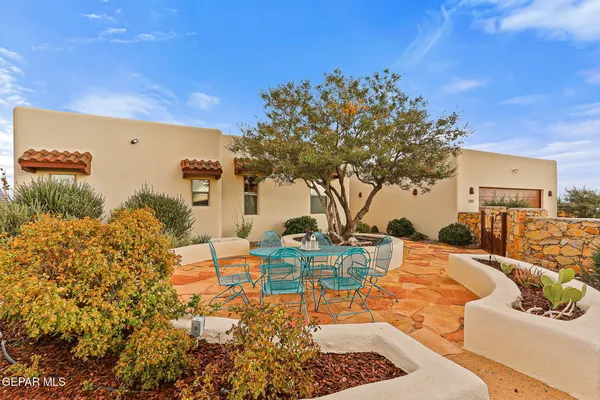 a view of a backyard with plants and a patio