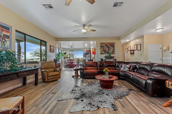a living room with fireplace furniture and a large window