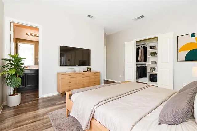 a bedroom with a bed and a flat screen tv