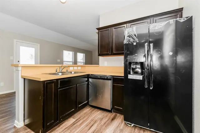 a kitchen with granite countertop a sink and stainless steel appliances