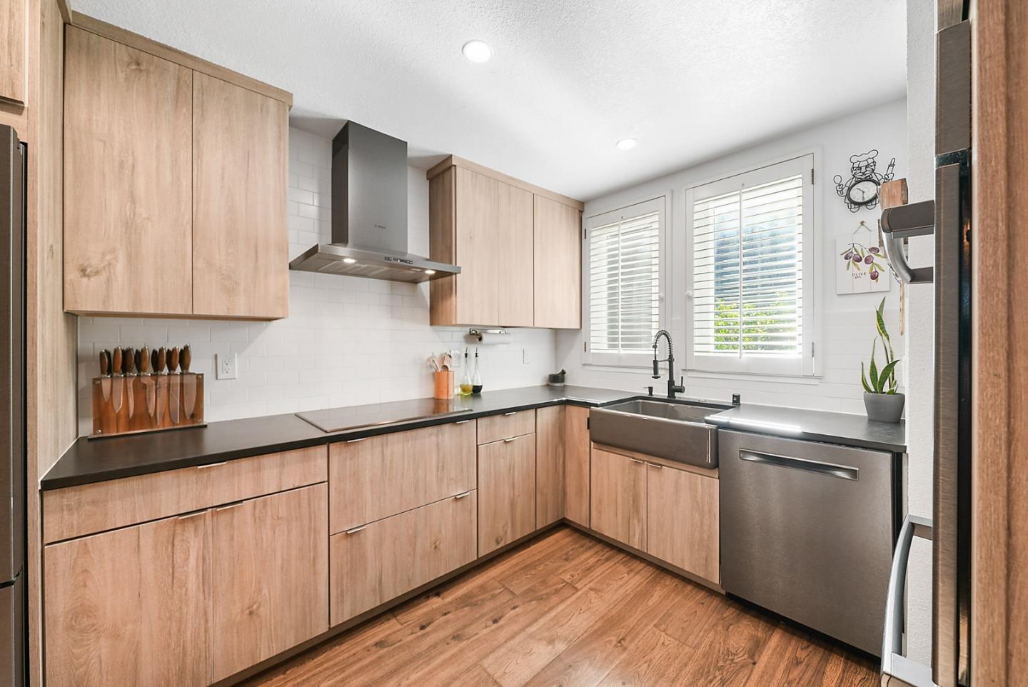 252 Bay Vista Circle Sausalito, CA 94965 - Photo 4 of 35 a kitchen with stainless steel appliances granite countertop wooden cabinets a sink and a stove