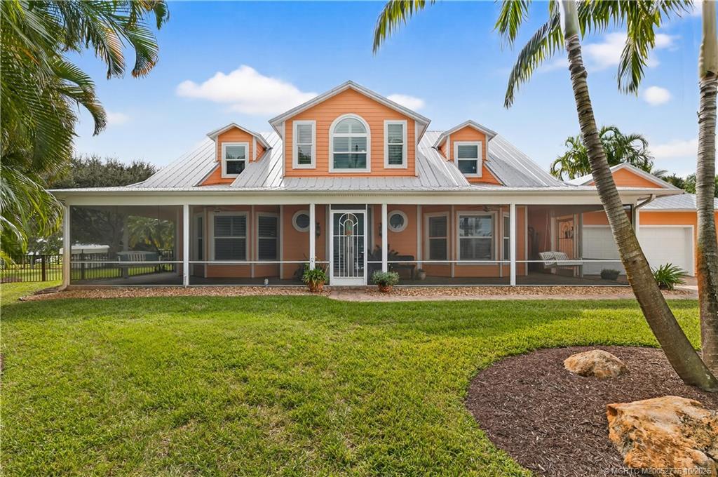 802 Southeast Portage Avenue Port St. Lucie, FL 34984 - Photo 11 of 48 front view of a house with a yard