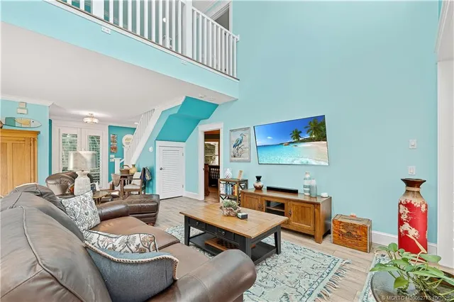 a kitchen with stainless steel appliances a refrigerator a stove a sink a dining table and chairs