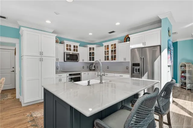 a kitchen with stainless steel appliances granite countertop a sink and a microwave