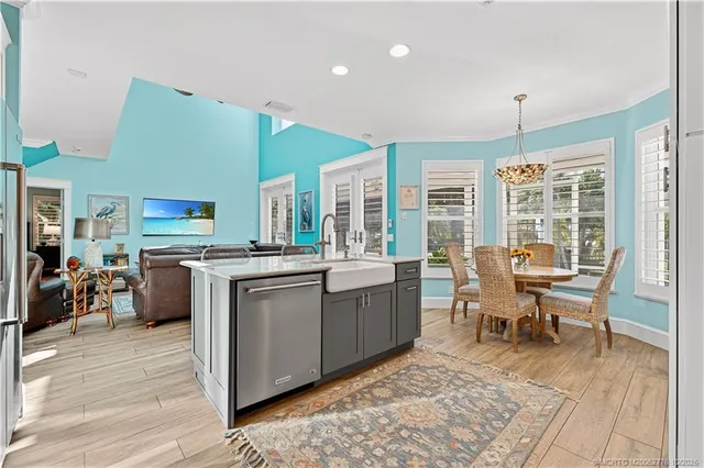 a kitchen with a sink a stove and chairs