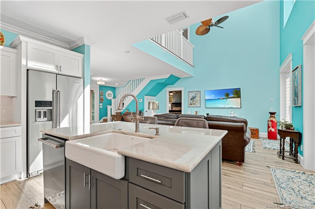 802 Southeast Portage Avenue Port St. Lucie, FL 34984 - Photo 20 of 48 a kitchen with a sink a stove and chairs