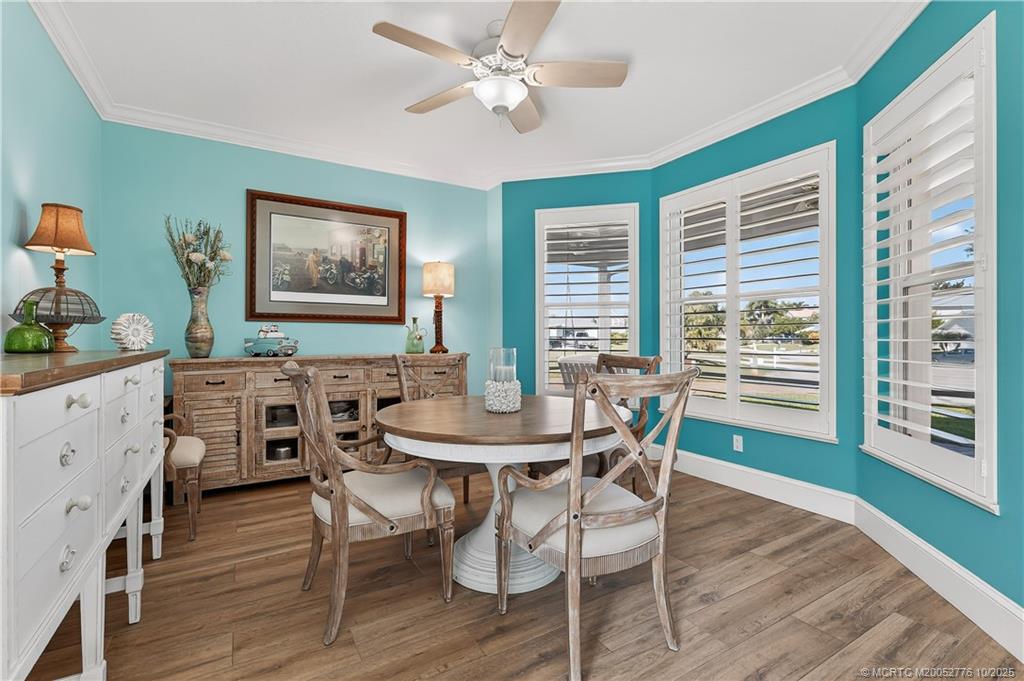 802 Southeast Portage Avenue Port St. Lucie, FL 34984 - Photo 22 of 48 a view of a dining room with furniture and wooden floor
