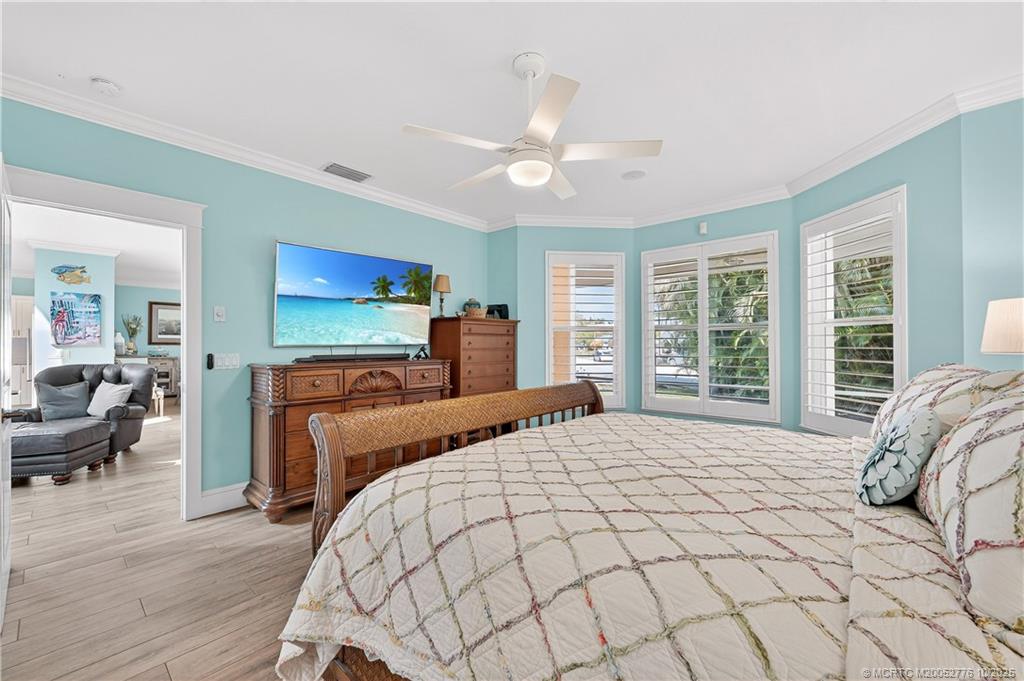 802 Southeast Portage Avenue Port St. Lucie, FL 34984 - Photo 25 of 48 a bedroom with a large bed and a tv
