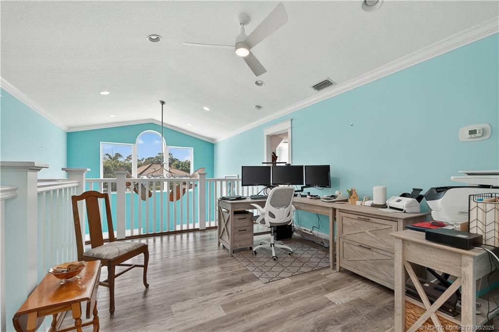 802 Southeast Portage Avenue Port St. Lucie, FL 34984 - Photo 30 of 48 a workspace with furniture and wooden floor