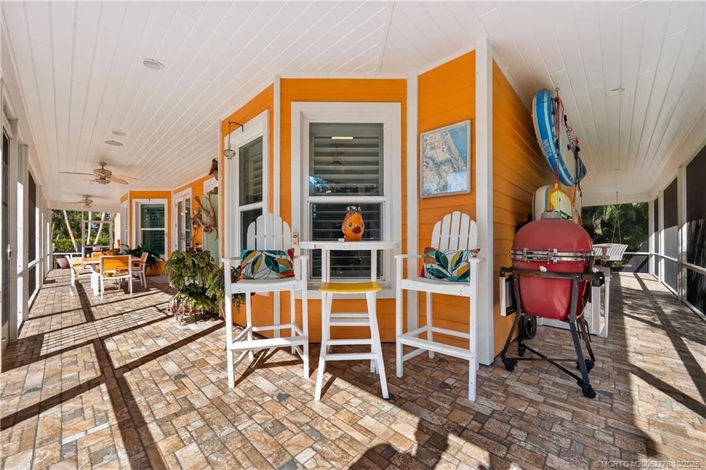 802 Southeast Portage Avenue Port St. Lucie, FL 34984 - Photo 37 of 48 a view of a dinning tables and chairs in a patio